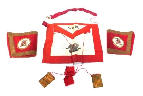 A group of RAOB regalia, comprising a red and cream apron bearing the initials KOM, and two sleeves each with enamel plaque bearing the initials KOM., boxed.