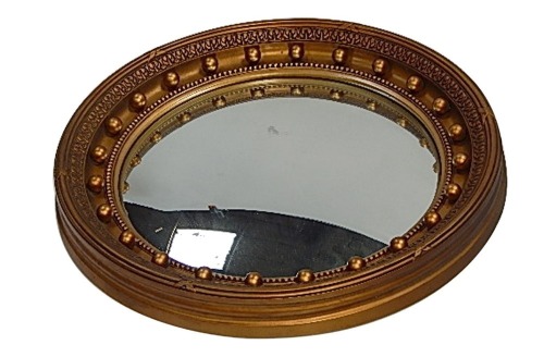 A 19thC gilt framed port hole mirror, with reeded and crossed border, with bulbous finials, convex central mirror plate, 41cm diameter.