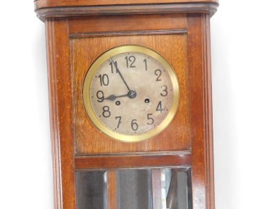 An oak wall clock, with silvered numeric dial and eight day movement, with fleur de lys crested top, above three glazed panel door, 80cm high, 32cm wide, 13cm deep. - 2