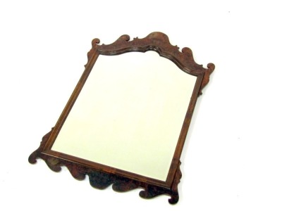 A George III style walnut fret work wall mirror, the arched scroll top with a rectangular bevelled mirror plate, 91cm x 64cm.