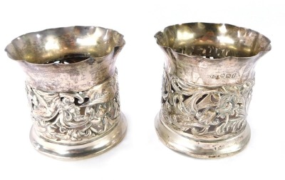 A pair of Edward VII silver bottle holders, with pierced and embossed decoration of birds, flowers and foliate scrolls, William Comyns & Sons, London 1901, 5¼oz. (AF)