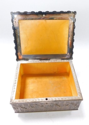 A late 19thC silver plated sewing box, the rectangular top with raised relief figures of cherubs, trees and flowers, opening to reveal a mustard lined interior, with bee stamp and double G to underside, 8cm high, 17cm wide, 12cm deep. - 4