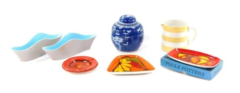 A group of Poole and other pottery, comprising a Poole ashtray, a Poole orange pin dish, a cased orange Poole trinket tray, two blue wave design storage jars, a TG Green Cornishware yellow jug, and a modern blue and white ginger jar. (7)