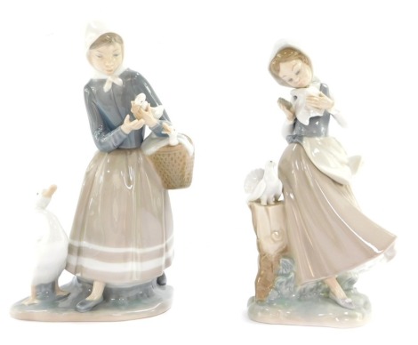 Two Lladro figures, comprising a girl with dove, 22cm high, and a lady carrying goslings, 22cm high. (2)