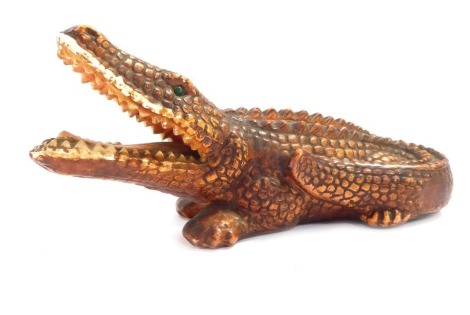 A Continental ceramic alligator money box, stamped Foreign, 20cm wide.