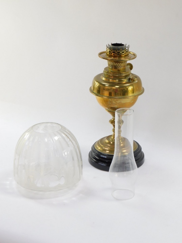 A Victorian brass oil lamp, with a pleated glass shade, floral applied