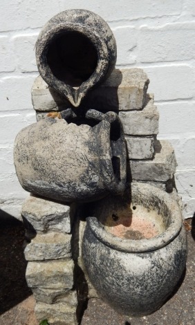 A plastic water feature, of three urns, on brick support, 53cm high.