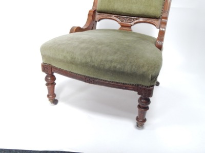 An Edwardian oak nursing chair, with turned legs, terminating in castors, 90cm high. - 3