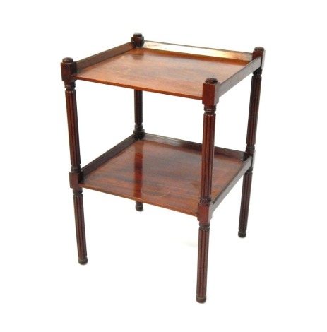 A 19thC mahogany two tier side table, on reeded column supports, 68cm high, 46cm wide, 43cm deep.