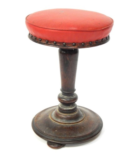 A Victorian mahogany piano stool, with red leatherette top, on bun feet, 48cm high.