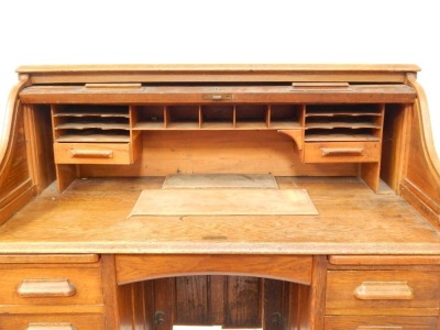 An Edwardian oak roll top writing desk, with S shape tambour opening to reveal a fitted interior, on pedestals of four drawers, 117cm high, 114cm wide, 65cm deep. - 2