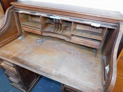 An Edwardian oak roll top writing desk, with S shape tambour, opening to reveal fitted sections above two pedestal each with three drawers, 124cm high, 125cm wide, 72cm deep. - 2