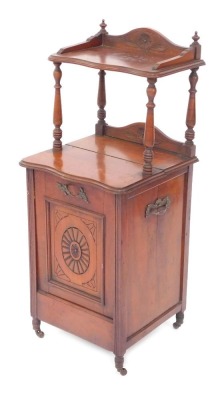 An early 20thC mahogany purdonium, with raised gallery shelf, and cupboard base with carved door, terminating in castors, 91cm high, 39cm wide, 36cm deep.