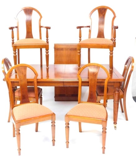 A walnut dining suite, comprising inlaid extending dining table and six matching chairs, including two carvers, the table 75cm high, 166cm wide, additional 51cm leaf, 111cm deep. (7)