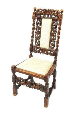 A 19thC oak hall chair, with heavily carved relief back, with two figures and crown, with drop-in seat and cushion.