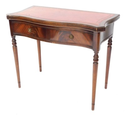 A mahogany card table, the shaped top with red leather inset top, above single drawer on tapered legs, 76cm high, 91cm wide, 43cm deep.