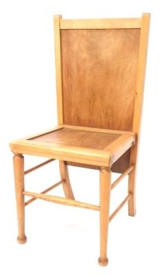 An Arts & Crafts style light beech chair / trouser press, with solid seat and back, raised on turned legs, united by spindles, 89cm high, 40cm wide, 38cm deep.