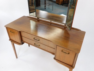 A 1960's hardwood dressing table, with triple mirror, above two drawers and two cupboards, on tapered legs, with associated stool, 142cm high, 107cm wide, 44cm deep. The upholstery in this lot does not comply with the 1988 (Fire & Fire Furnishing) Regulat - 2