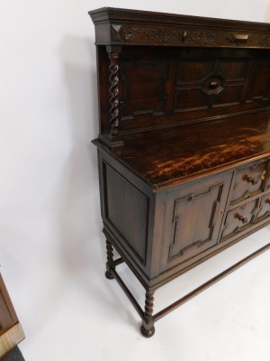 An early 20thC oak dresser, the carved panelled back with two barley twist columns on sideboard base, with arrangement of two drawers and two cupboards, on rectangular base with bun feet, 147cm high, 153cm wide, 52cm deep. - 3