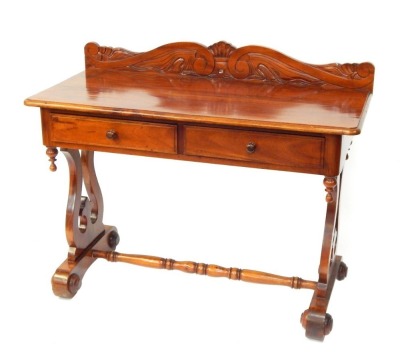 An Eastern hardwood Victorian style writing desk, with scroll carved back, above two drawers, on lyre supports, 90cm high, 110cm wide, 53cm deep.