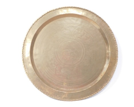 A brass charger, of Eastern design with fluted border, 70cm diameter.