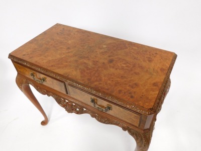 A reproduction burr walnut writing desk, with carved border and two drawers, on cabriole legs, 80cm high, 87cm wide, 46cm deep. - 2