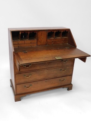 A Georgian oak bureau, with fall flap revealing a fitted interior, above an arrangement of two short and three long drawers, on bracket feet, 113cm high, 106cm wide, 53cm deep. - 2