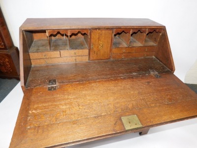 A Georgian oak bureau, with fall flap revealing a fitted interior, above an arrangement of two short and three long drawers, on bracket feet, 113cm high, 106cm wide, 53cm deep. - 3