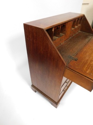 A Georgian oak bureau, with fall flap revealing a fitted interior, above an arrangement of two short and three long drawers, on bracket feet, 113cm high, 106cm wide, 53cm deep. - 4