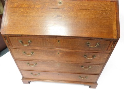 A Georgian oak bureau, with fall flap revealing a fitted interior, above an arrangement of two short and three long drawers, on bracket feet, 113cm high, 106cm wide, 53cm deep. - 5