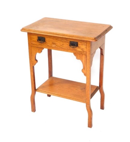 An Art Nouveau style oak side table, with rectangular top above single drawer with metal escutcheons, out step legs, 73cm high, 60cm wide, 31cm deep.