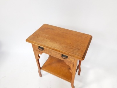 An Art Nouveau style oak side table, with rectangular top above single drawer with metal escutcheons, out step legs, 73cm high, 60cm wide, 31cm deep. - 2