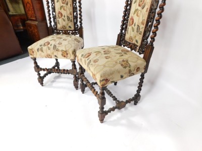 A pair of early 20thC carved oak hall chairs, with leaf carved and moulded back, barley twist column supports, with cream upholstery, 115cm high. - 3