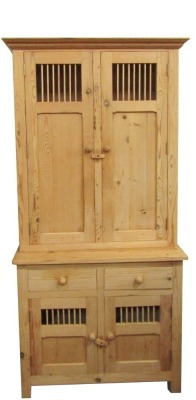 An early 20thC stripped pine kitchen cabinet, the top with two cupboard doors, above a plain base, 196cm high, 95cm wide, 48cm deep.