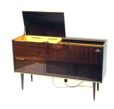 A Grundig radiogramme, in a glossed mahogany case, with Grundig automatic record player, on tapered legs, 74cm high, 122cm wide, 37cm deep. Buyer Note: WARNING! This lot contains untested or unsafe electrical items. It is supplied for scrap or recondition