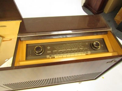 A Grundig radiogramme, in a glossed mahogany case, with Grundig automatic record player, on tapered legs, 74cm high, 122cm wide, 37cm deep. Buyer Note: WARNING! This lot contains untested or unsafe electrical items. It is supplied for scrap or recondition - 2