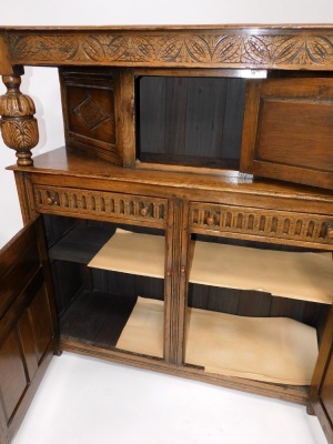 A carved oak court cupboard, the shelf top with single cupboard door, on bulbous finials, above two long drawers and cupboard base, 144cm high, 140cm wide, 45cm deep. - 3