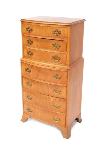 A reproduction walnut chest on chest, with arrangement of three over four drawers, with brass handles, on out splayed bracket feet, 108cm high, 52cm wide, 34cm deep.