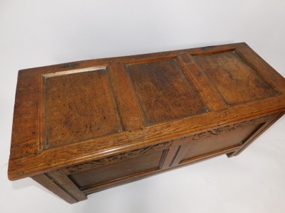 A 17thC carved oak coffer, with two panels top and front, Arabesque frieze, on stiles, 56cm high, 115cm wide, 46cm deep. - 4