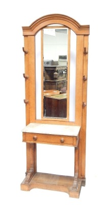 A late 19thC Continental light oak marble topped hall stand, the rectangular bevelled mirror back, with arrangement of six hooks, with marble top above single drawer, with block base and arch top, 208cm high. 73cm wide, 40cm deep.