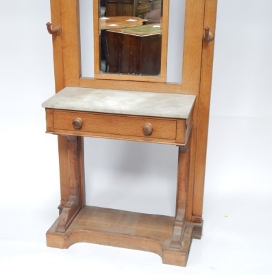 A late 19thC Continental light oak marble topped hall stand, the rectangular bevelled mirror back, with arrangement of six hooks, with marble top above single drawer, with block base and arch top, 208cm high. 73cm wide, 40cm deep. - 2