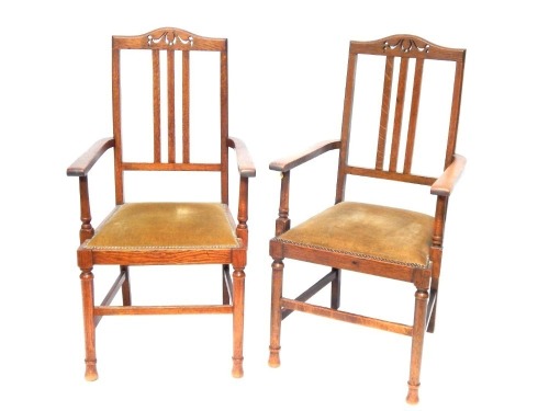 A pair of Edwardian carved oak carver chairs, with turned legs, 105cm high.