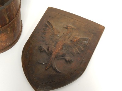 A mahogany wash pail, 57cm high, together with a carved shield of an eagle, 50cm high. (2) - 2