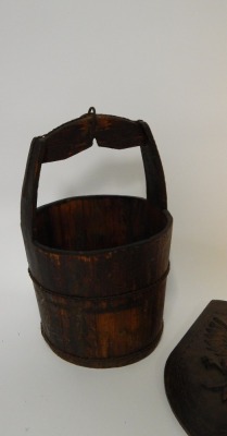 A mahogany wash pail, 57cm high, together with a carved shield of an eagle, 50cm high. (2) - 3