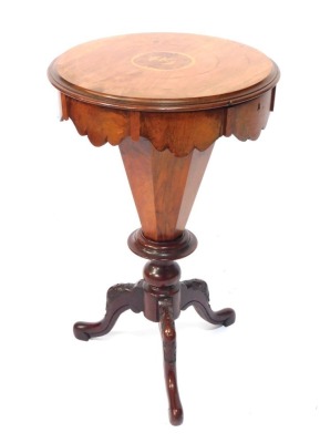 A Victorian walnut trumpet sewing table, the circular top with parquetry inlaid of birds, and ring banding, with shaped and moulded supports on a mahogany tripod base, 70cm high, 43cm diameter.