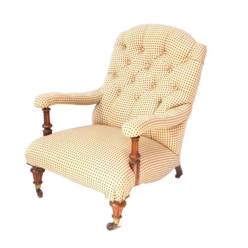 A Victorian walnut framed open armchair, with red and cream button back