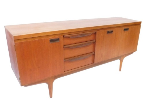 A teak sideboard, with three cupboard doors and three drawers, each with moulded handles, on tapered supports, 77cm high, 176cm wide, 45cm deep. (AF)