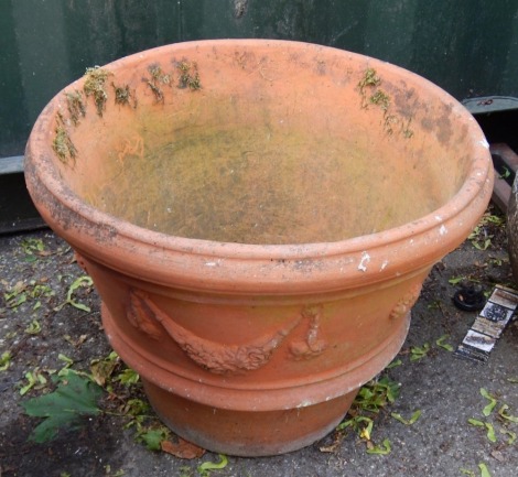 A terracotta planter, with Neo Classical flower swag design, 41cm high.