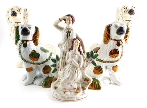 Various Staffordshire pottery, a pair of spaniel figures with gilt highlights and yellow eyes, with gilt padlocks, 28cm high, a green and gilt pair smaller, and a single Staffordshire figure of a lady and gentleman. (5)