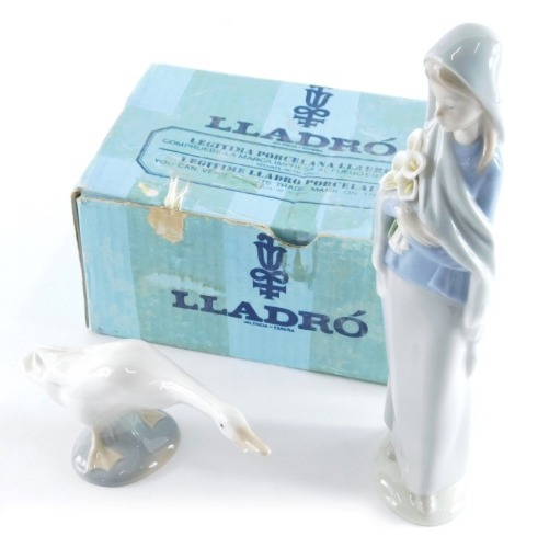 A Lladro figure of a lady, in flowing robes holding flowers, 24cm high, and a Lladro figure of a goose, partially boxed. (2)